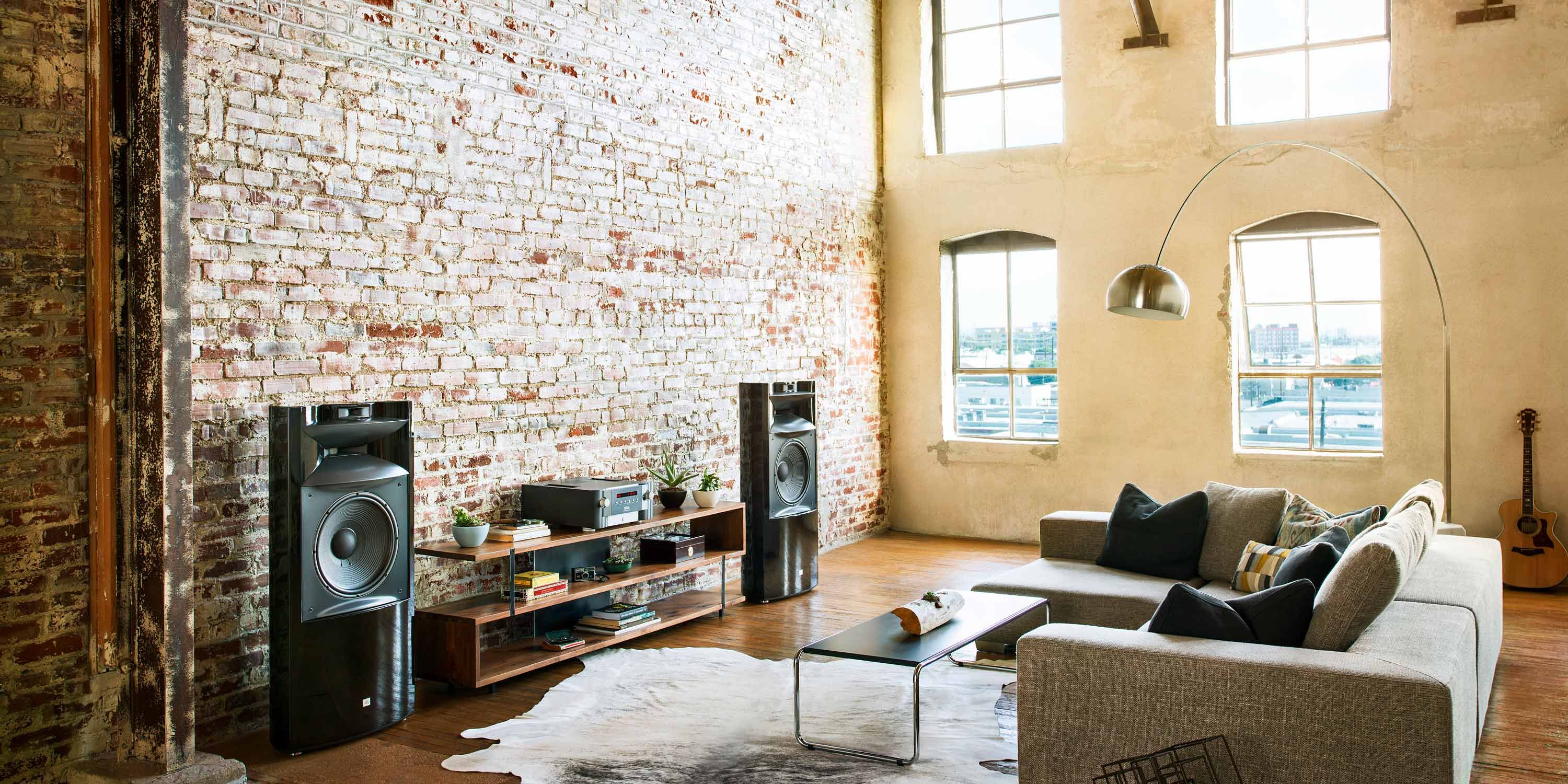 listening room with JBL speakers and brick walls